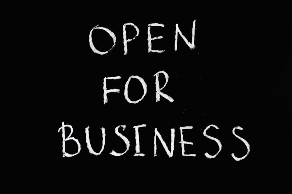Chalkboard with 'Open for Business' text in white chalk on black background.